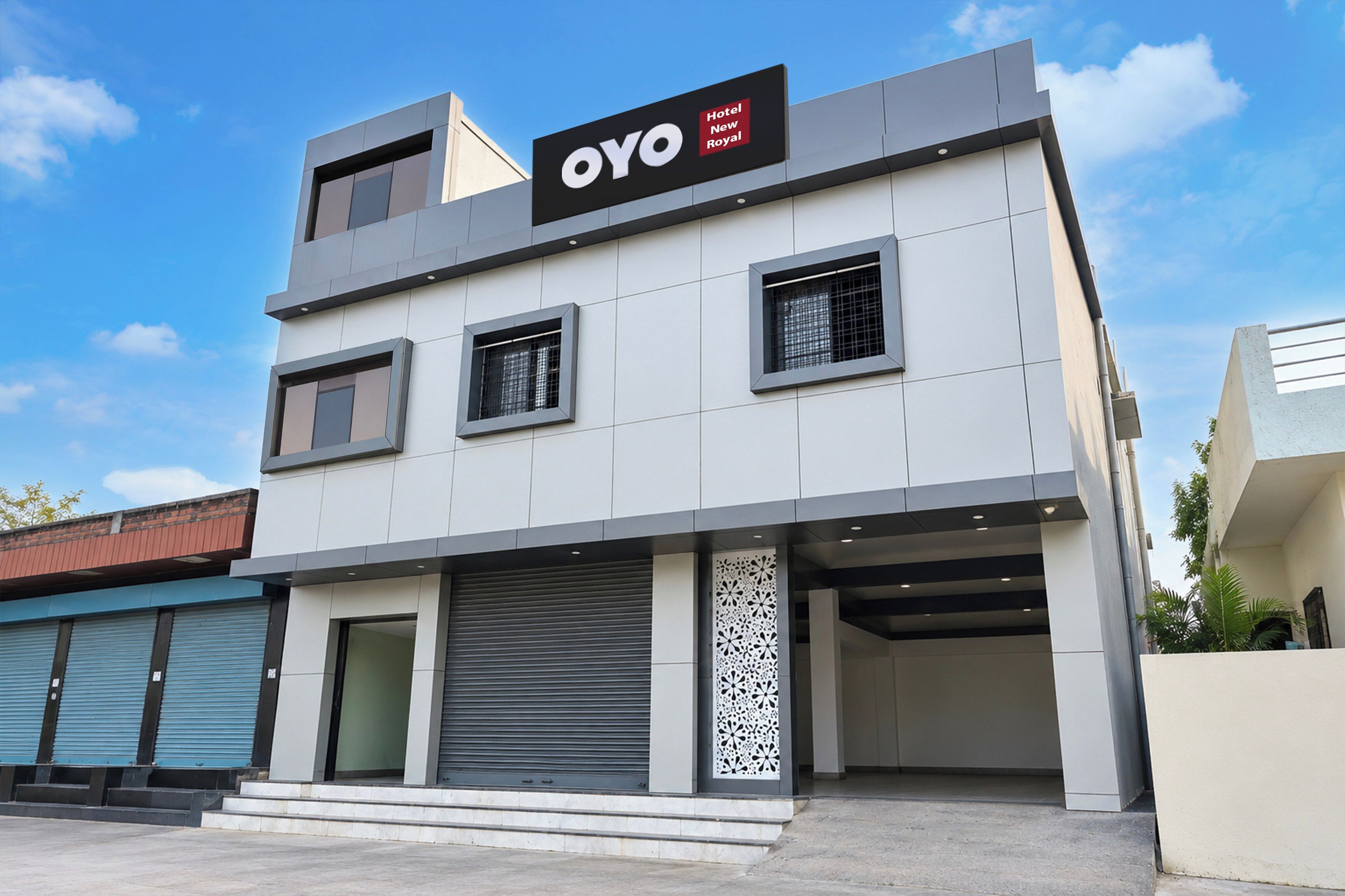 A modern hotel building with a sign reading 'OYO Hotel New Royal'.