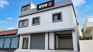 A modern hotel building with a sign reading 'OYO Hotel New Royal'.