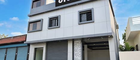 A modern hotel building with a sign reading 'OYO Hotel New Royal'.