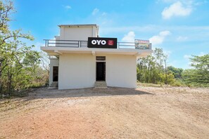 A two-story building with a sign that reads 'OYO Hotel Lake Nature Valley'.