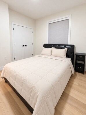 Separate bedroom with one queen bed and bed linens. - Ladner suite, kitchen, A/C and laundry (Delta)