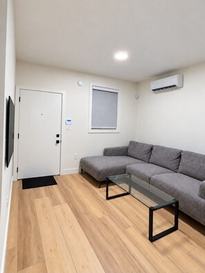 Unwind on the sectional with a TV and air conditioning in your private suite. - Ladner suite, kitchen, A/C and laundry (Delta)