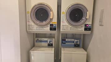 Two wall-mounted washing machines with control panels, each with a water level indicator and a digital display.