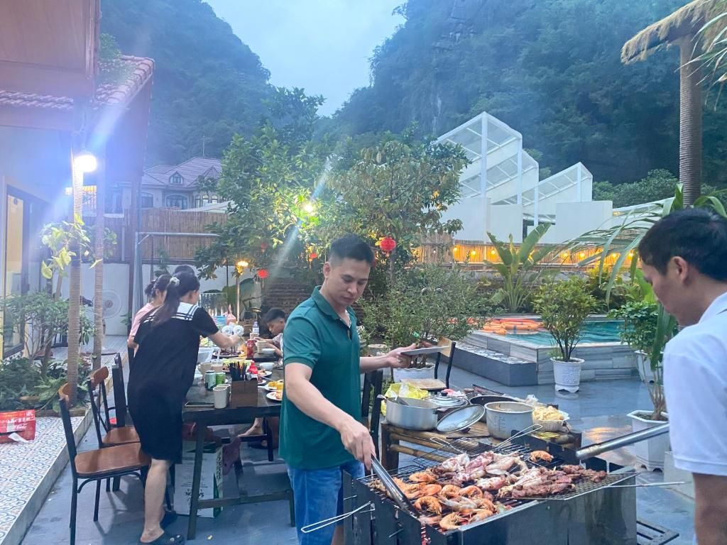 Un área de comedor al aire libre con una parrilla, mesas y sillas.