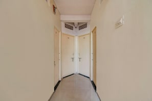 A corridor with two doors, each marked with a number. - Hotel O The Golden Key (Nagpur)