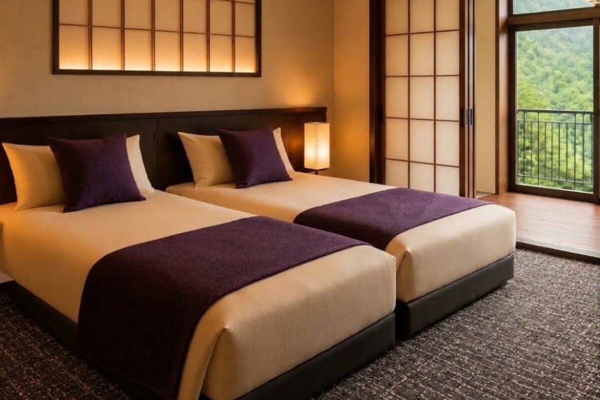 A hotel room with two beds, a large window, and a traditional sliding door.