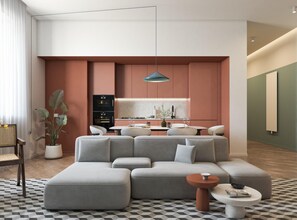 A modern living room with a sectional sofa, a dining table, and a kitchen area with a built-in oven. - MAIN Exclusive Apartments - Toledo (Napoli)