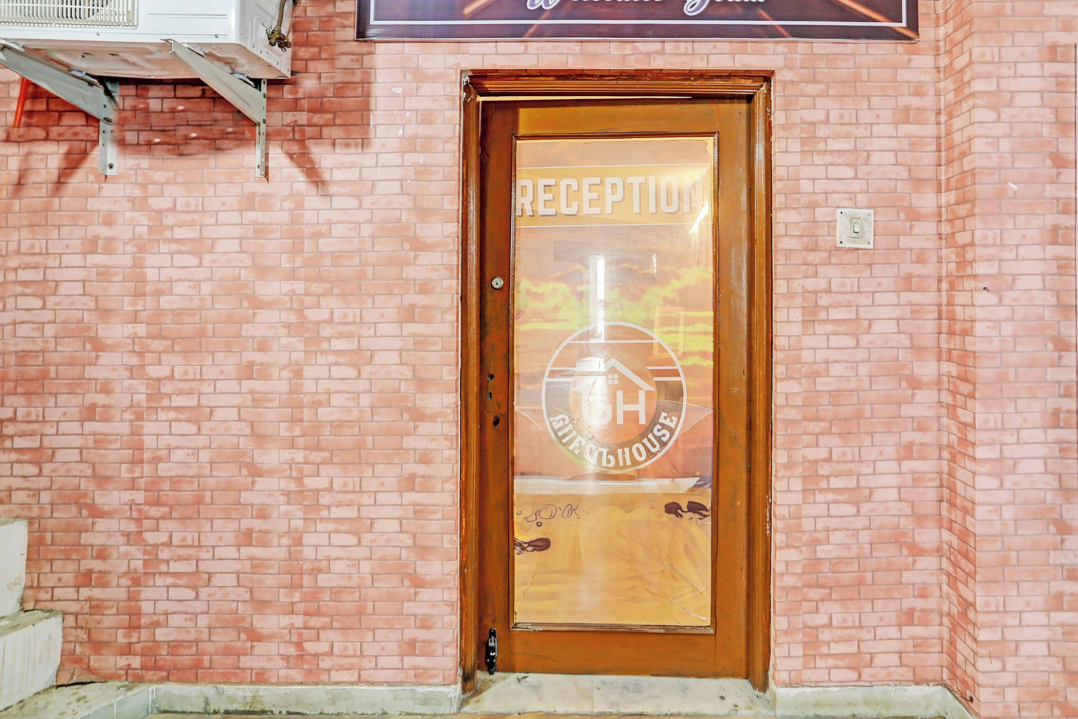 A reception door with a glass panel displaying a logo and the word 'RECEPTION'.