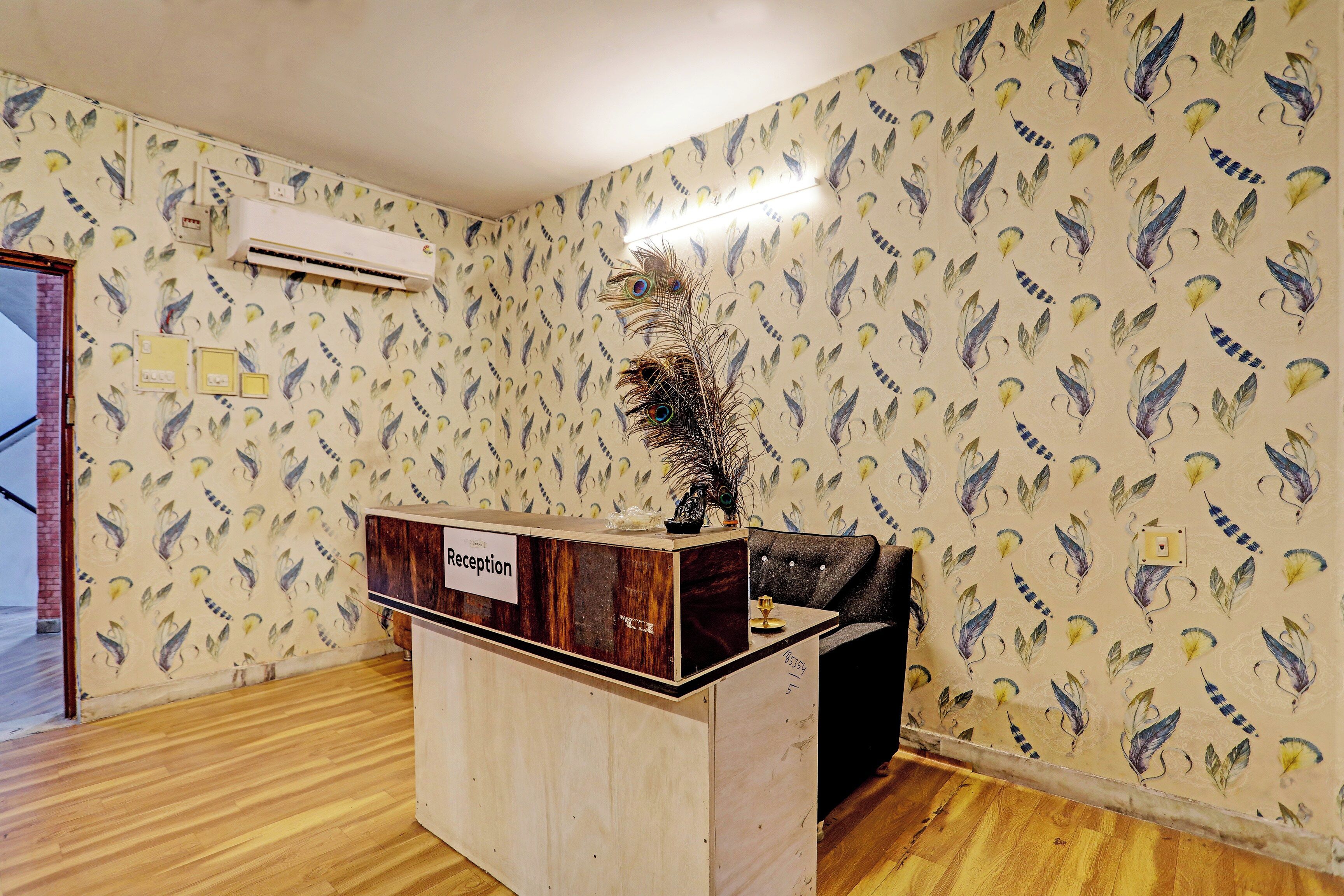 A reception desk with a wooden finish and a sign labeled 'Reception'.