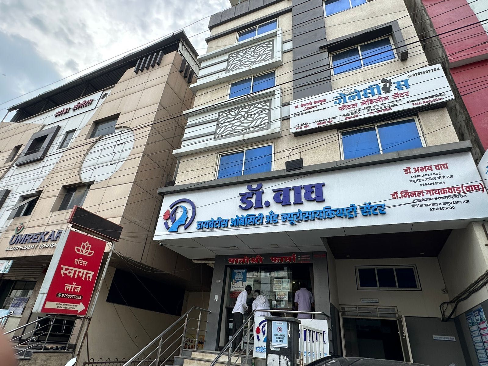 Un edificio de varios pisos con varias indicaciones, incluyendo una para un hospital y otra para una clínica dental.