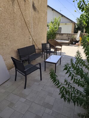 An outdoor seating area with a sofa, chairs, and a table. - privet house near Jerusalem (Bet Shemesh)