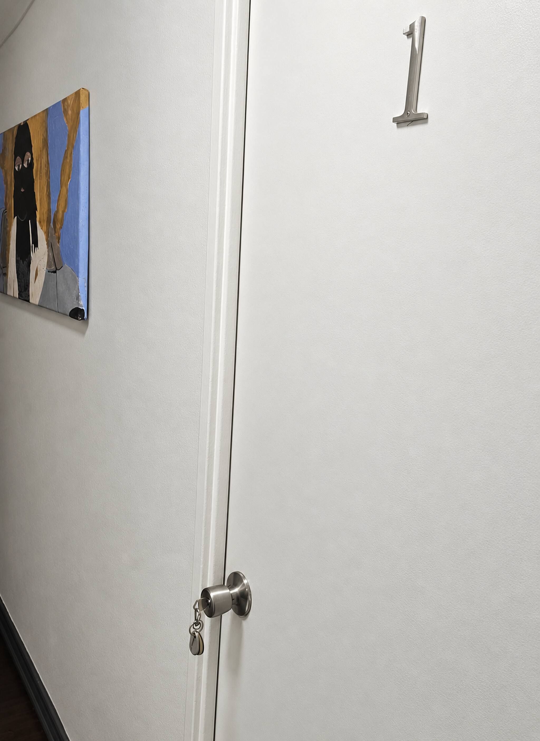 A door with a keyhole and a number '1' sign above it.