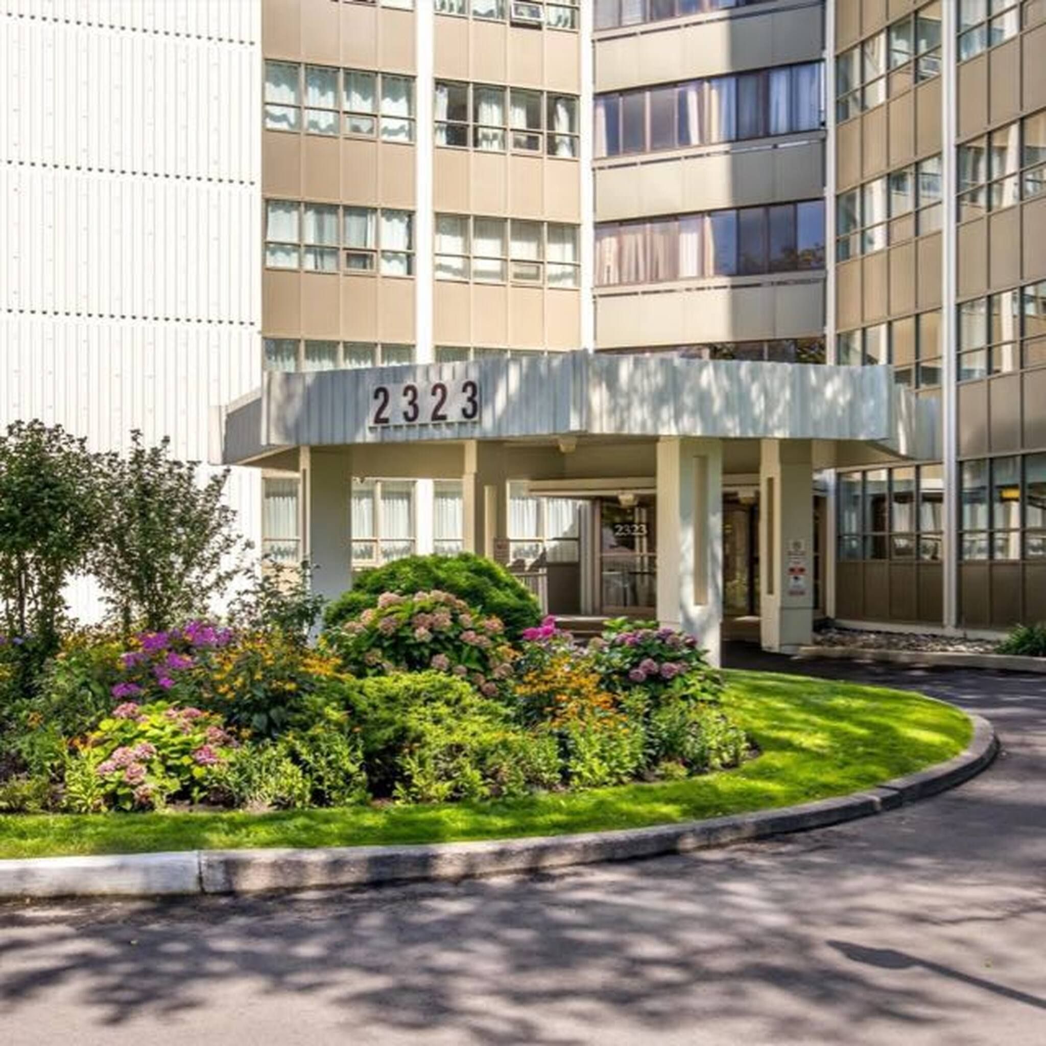 A multi-story hotel building with a prominent entrance number '2323'.