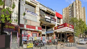 A street view with multiple commercial buildings, including a dental clinic, a bank, and a restaurant.