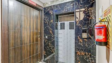An elevator with a fire extinguisher mounted on the wall and a sign indicating the 2nd floor.