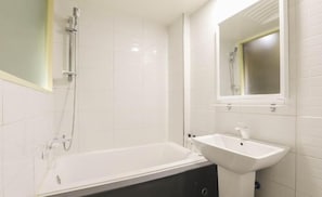A bathroom with a bathtub, a sink, and a shower. - The Stay Nangman Taejeon (Daegu)