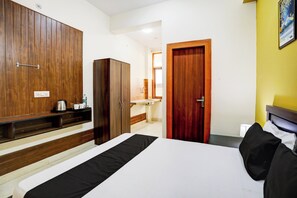 A hotel room with a bed, a wardrobe, a desk with a kettle, and a bathroom visible through an open door. - Hotel O Galaxy inn (Noida)