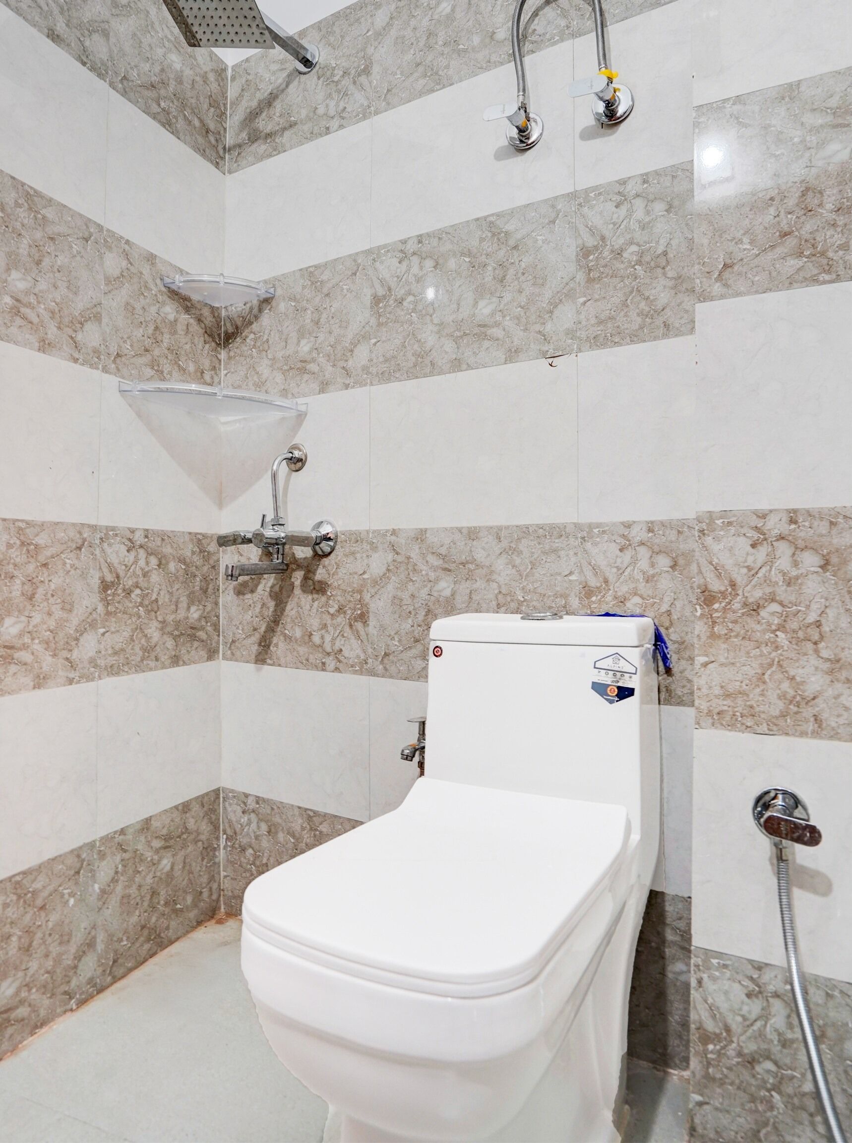 A bathroom with a toilet, a shower, and a sink.