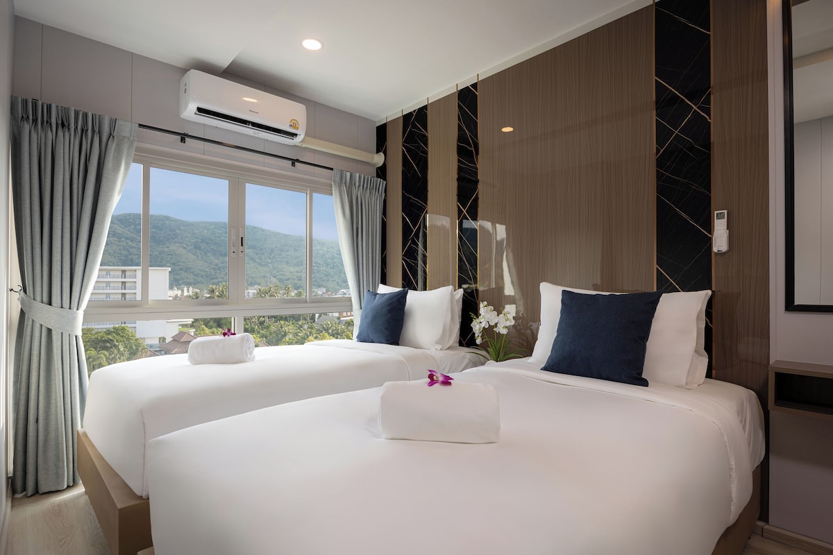 Ein Hotelzimmer mit zwei Betten, einer Klimaanlage, Bergblick und modernem Design.