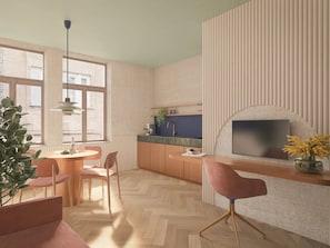 Cozinha moderna com área de refeições, TV presa a parede texturizada e grande janela que oferece luz natural.