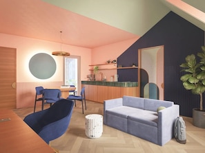 Uma sala de estar moderna com sofá, cadeiras, mesa de jantar e área de cozinha.