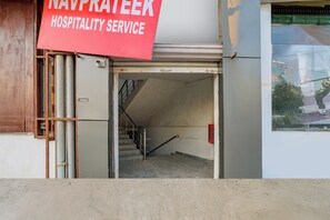A closed door with a sign indicating 'NAVPRATEEK HOSPITALITY SERVICE' above it.