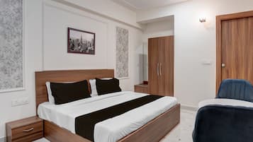 A bedroom with a wooden bed, bedside tables, a wardrobe, and a chair.