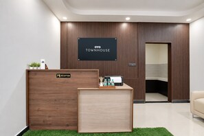 A reception desk with a sign reading 'Reception' and 'OYO TOWNHOUSE'. - Hotel O VINTAGE VAULTS (Noida)