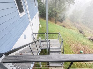 A wooden staircase leading to a house with a blue exterior. - 5-Bedroom, 4-Bathroom A-Frame Mountain House (Roaring Gap)