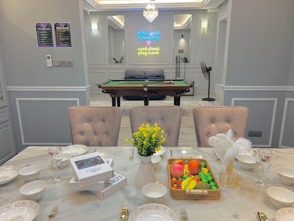 A hotel room with a pool table, a neon sign, and a dining area set with white tableware and chairs. - 22Pax PJ Karaoke & PS5 Landed Homestay by 4Balance (Petaling Jaya)