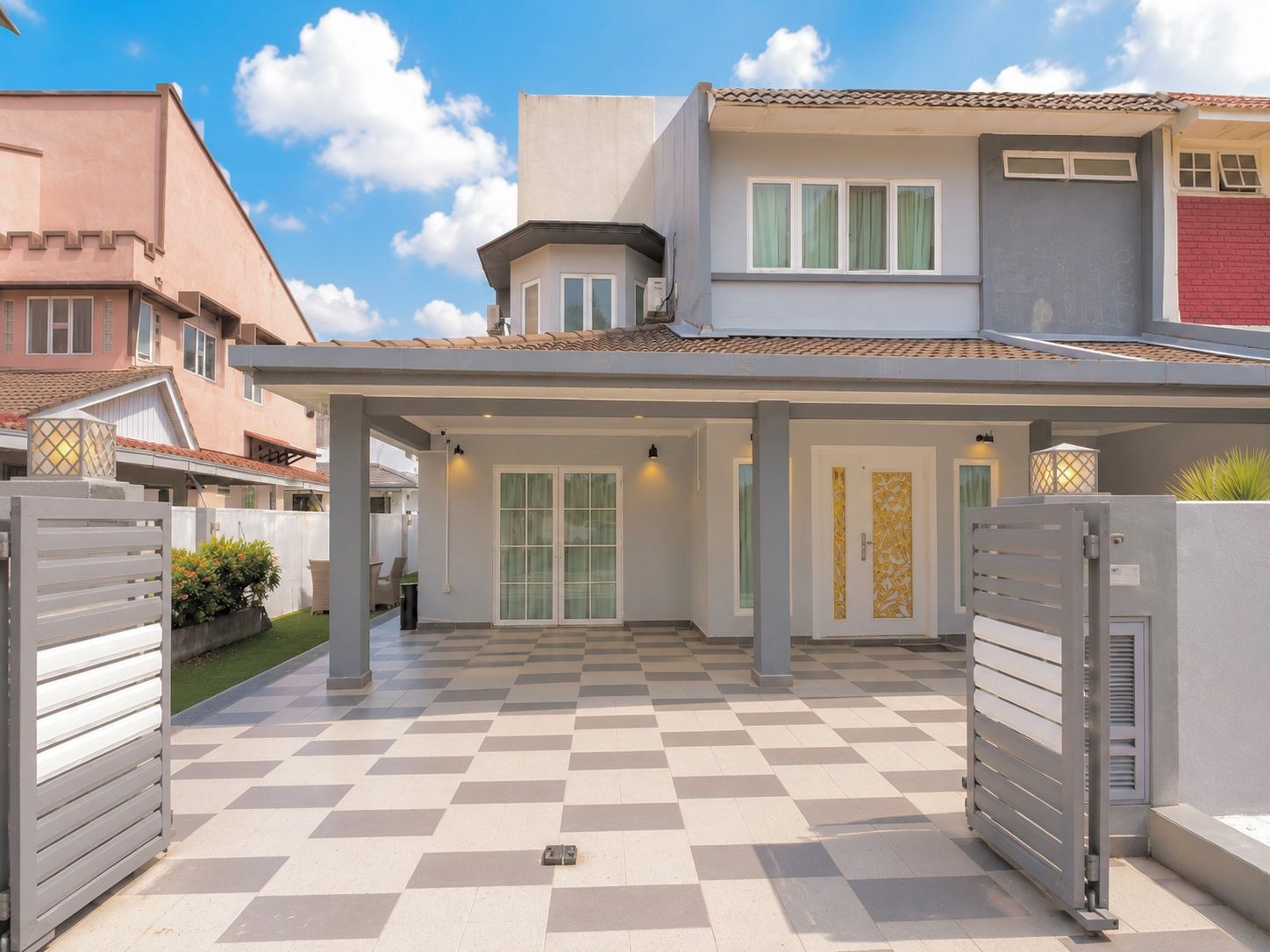 A residential property with a covered patio, a gated entrance, and a checkered floor.