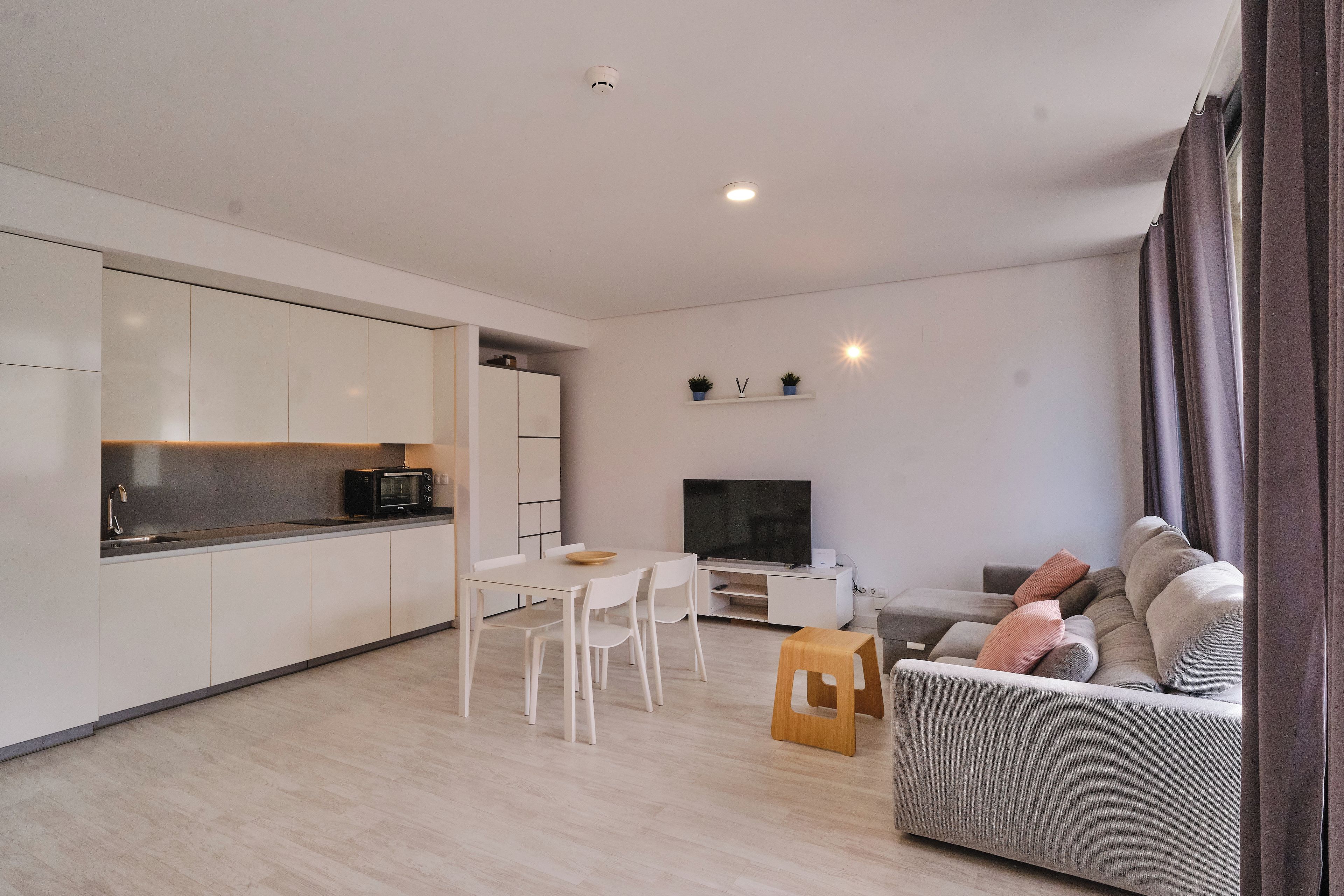 Un espace de vie moderne comprenant une cuisine, un coin repas et un espace salon.
