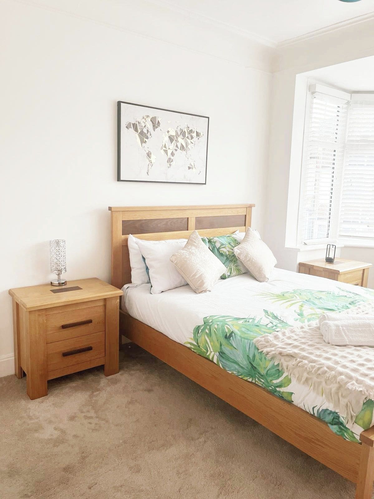 A cosy bedroom with one kind bed, a window with darkening blinds, and heating. Perfect for a comfortable stay, offering a peaceful space to rest, read, or relax after a day exploring the local area.