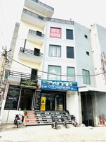 A multi-story building with a sign for 'Hotel Heaven' on the facade.