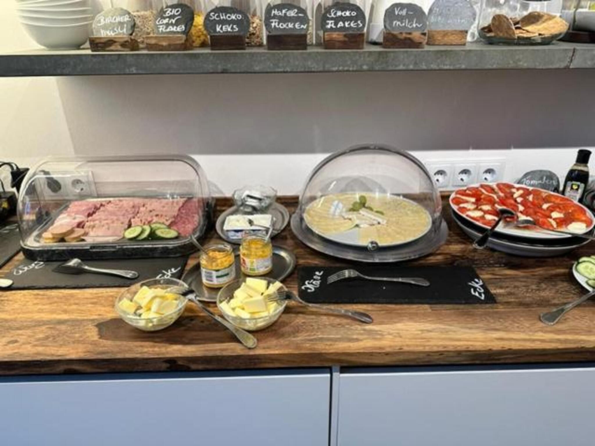 A buffet setup with various food items and condiments.