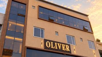 A modern building with a prominent 'OLIVER' sign on the facade.