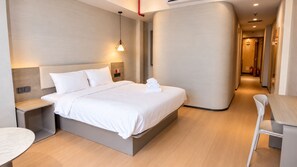 A modern hotel room with a bed, bedside table, and a chair. - SHANKEE Hotel Nguyen Thai Hoc (Ben Thanh)