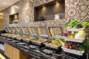 A buffet setup with multiple food stations and a variety of dishes. - Clubhouse Hotel by CheckIn Kolkata (Kolkata)