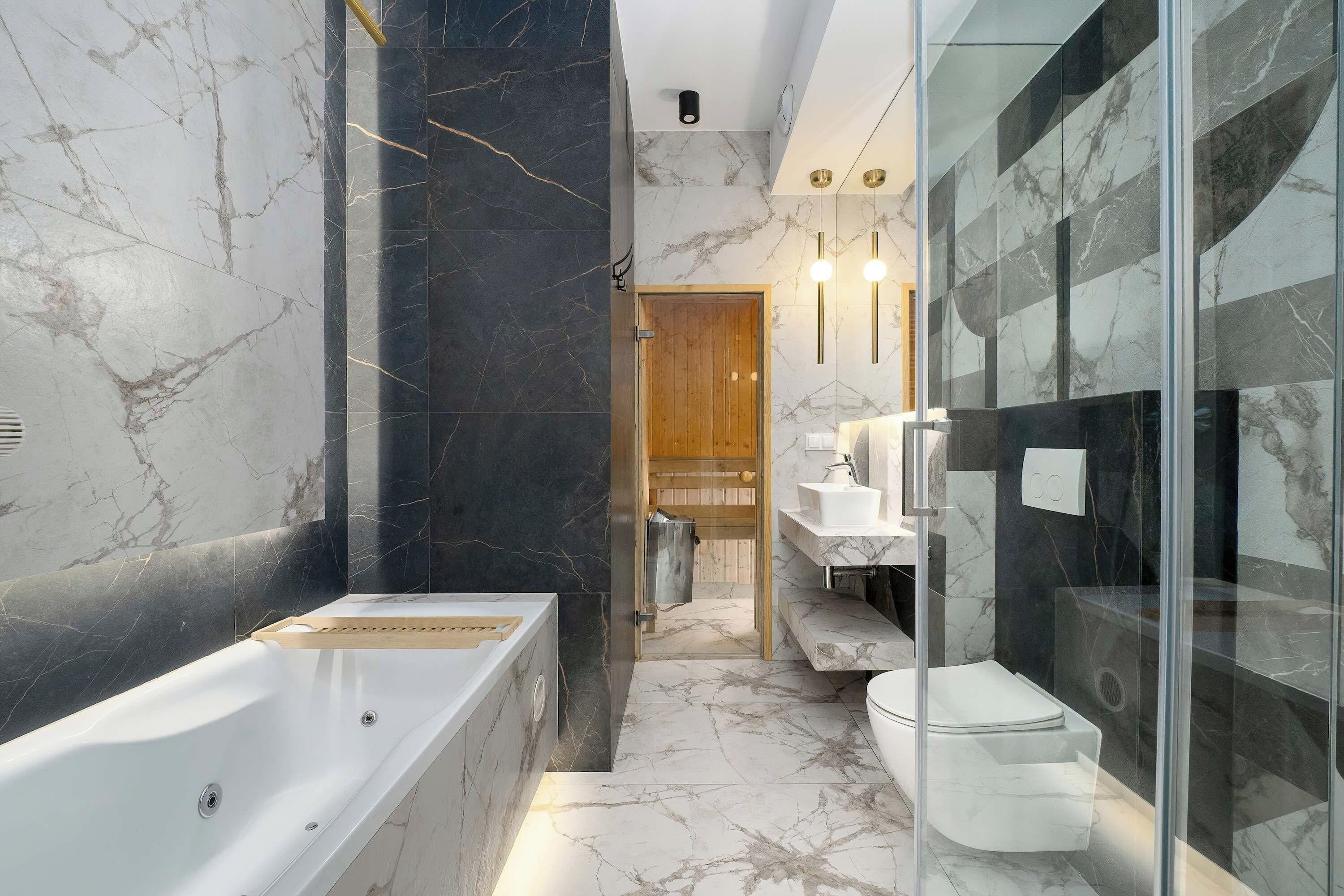 A modern bathroom with a freestanding bathtub, a glass-enclosed shower, and a toilet.