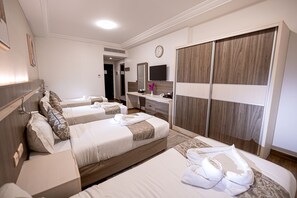 A hotel room with two beds, a vanity with a mirror, a television, and a wardrobe. - Romance Al-bait Hotel (makkah)