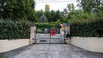 A gated entrance with a sign for 'SHARLEY MOLERIES SUB-ZONE' and a 'DOM LE SUDE' sign.