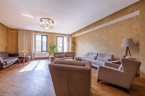 A spacious living room with a sofa set, a coffee table, and a lamp. - Marvelous 5-bedroom apartment with AC in charming Tbilisi (Tbilisi)