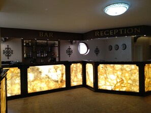 A reception area with a reception desk and a bar area.
