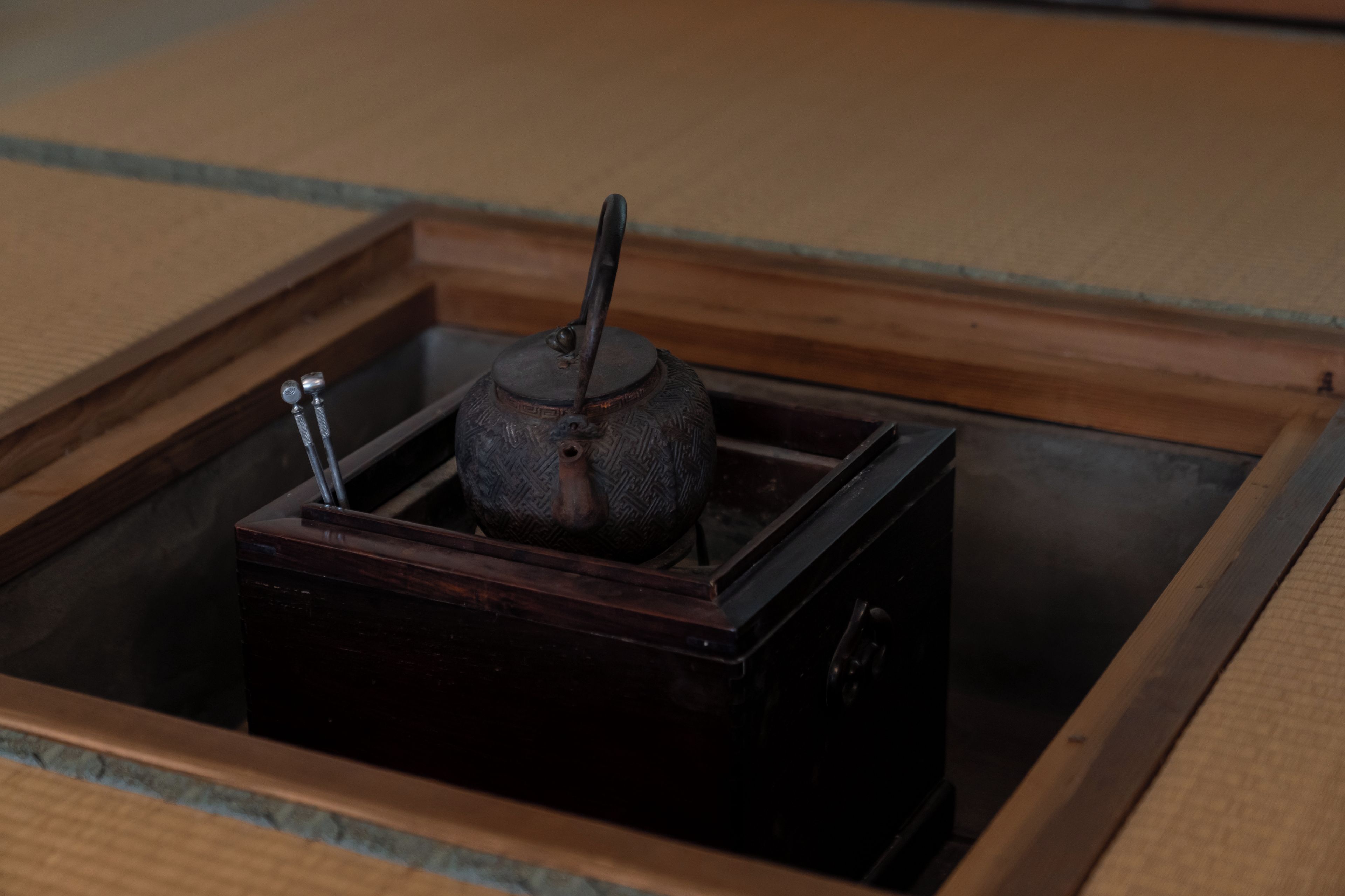 A traditional Japanese tea set in a wooden box.