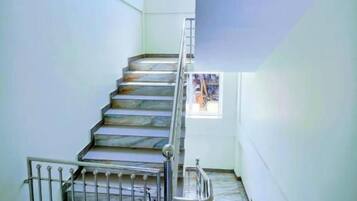 A staircase with metal railings leading to an upper floor.