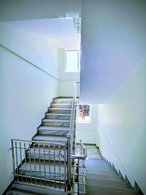 A staircase with metal railings leading to an upper floor. - Mangala Enclave  (Attingal)