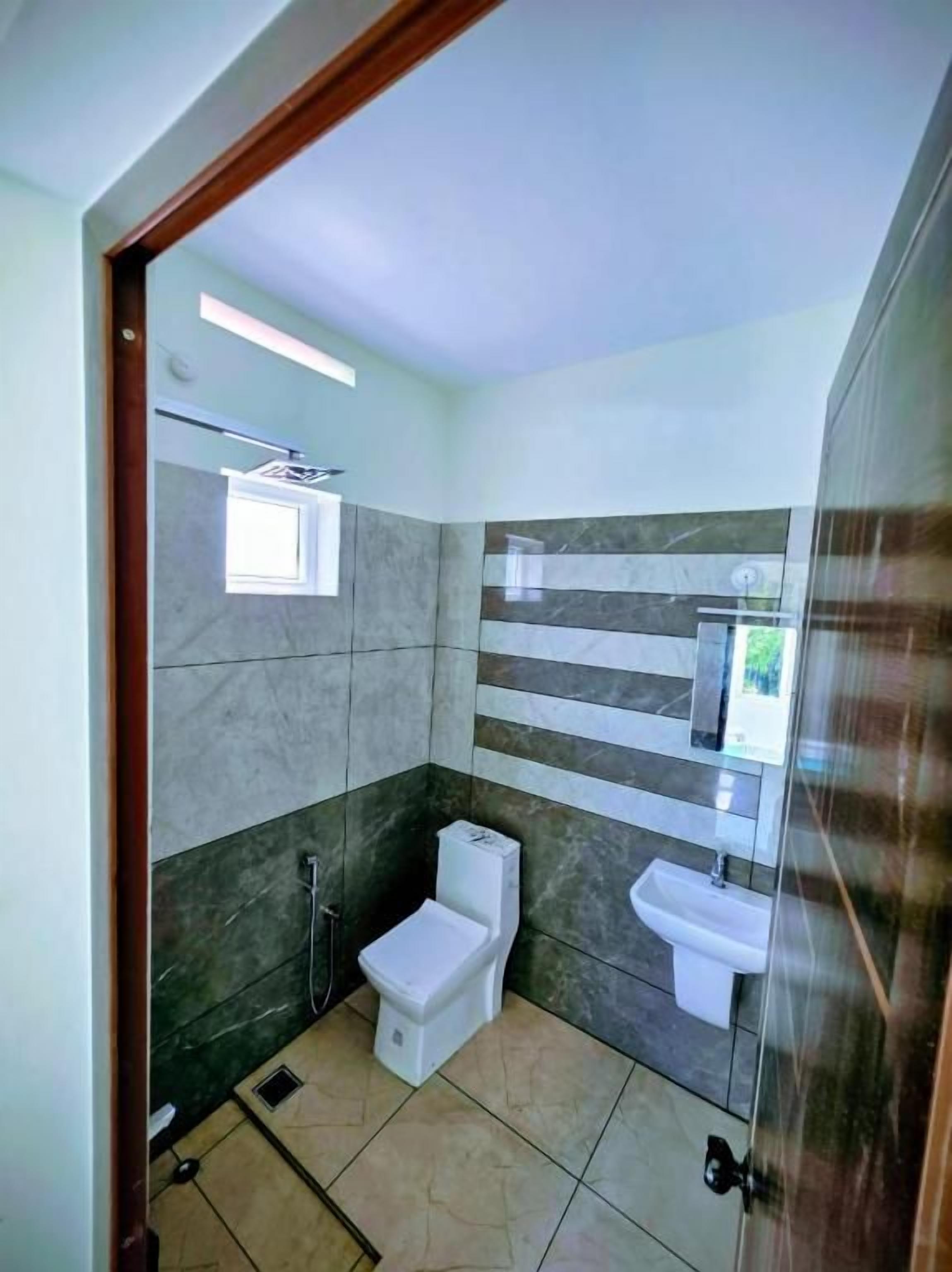 A bathroom with a toilet, bidet, and sink.
