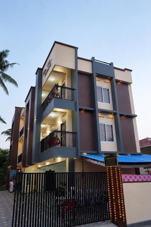 A multi-story residential building with balconies, a gated entrance, and a visible staircase. - Mangala Enclave  (Attingal)