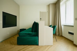 A modern room with a bed, a desk, and a chair. - New Listing (Dervio)