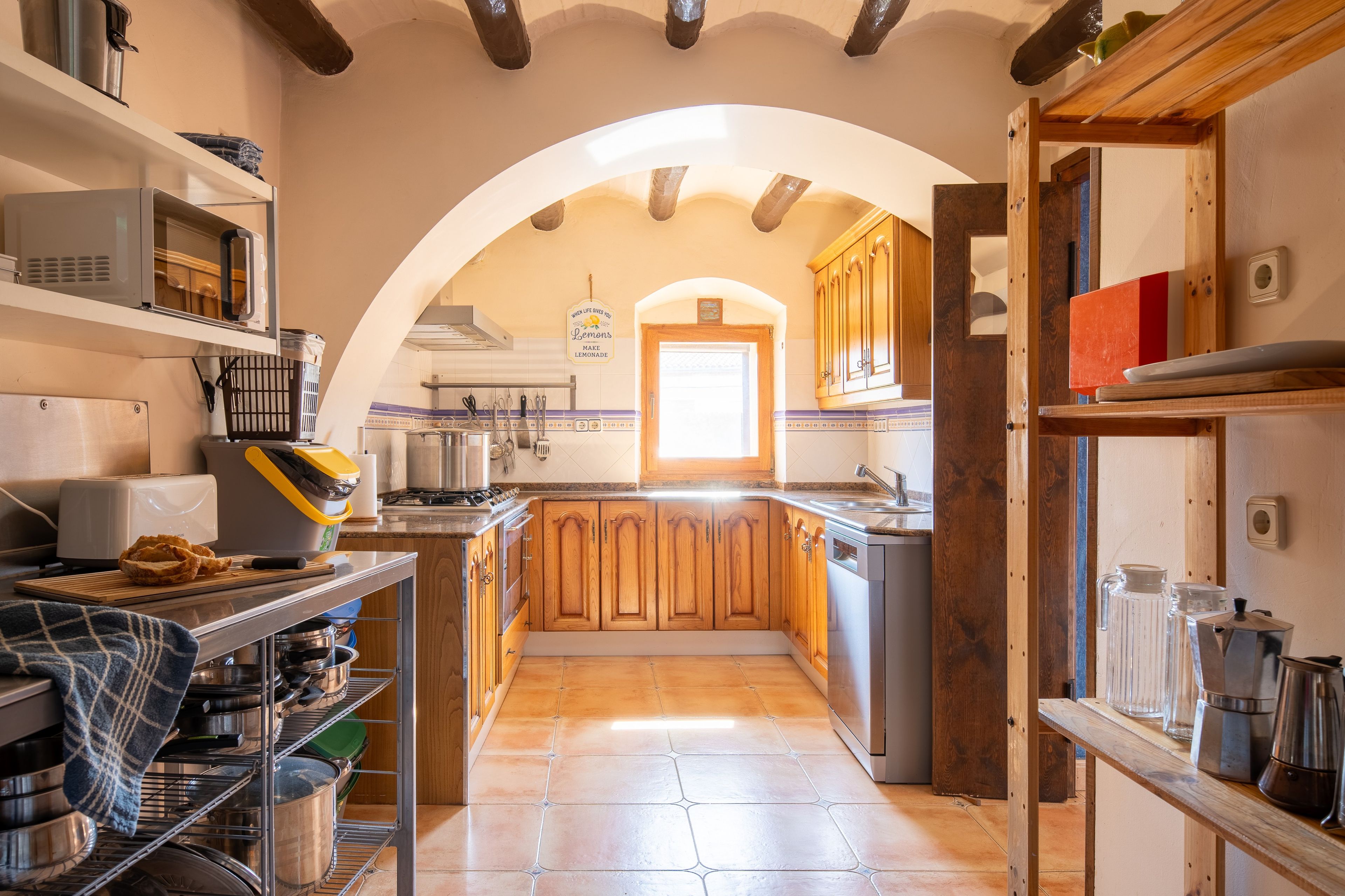 A kitchen with wooden cabinets, a central island, and a tiled backsplash.